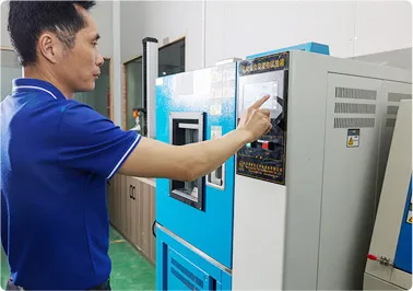 Quality control technician reviewing tensile test data on computer screen with testing machine in background